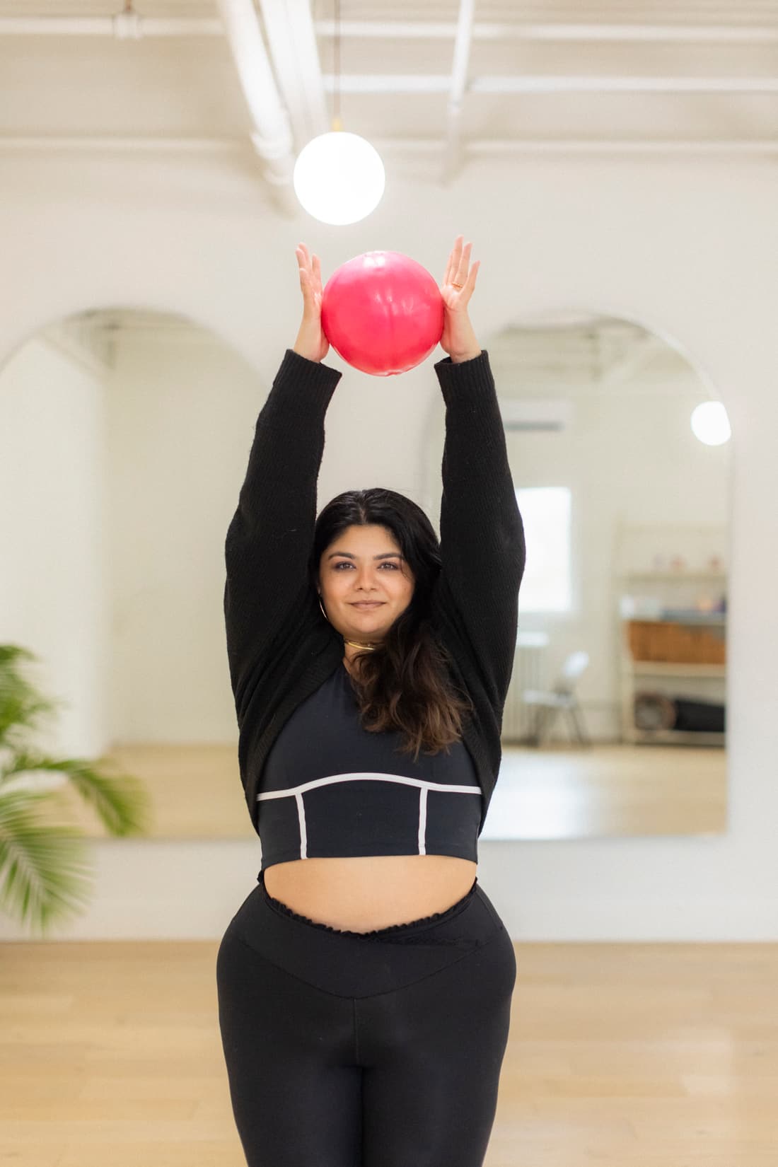 A student working with a small Pilates ball